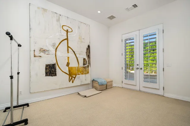 a bedroom with furniture and a chair