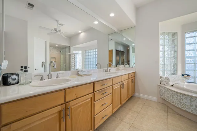 a spacious bathroom with a tub sink shower and mirror