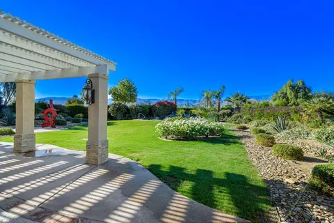 a view of a garden with a building in the background