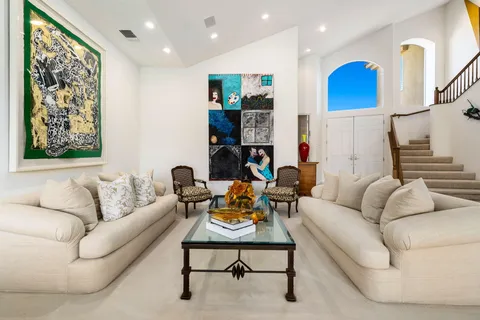 a living room with furniture and a chandelier