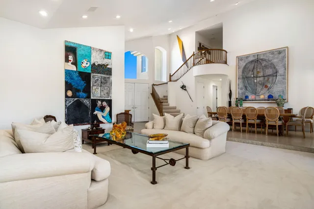 a living room with furniture and large window