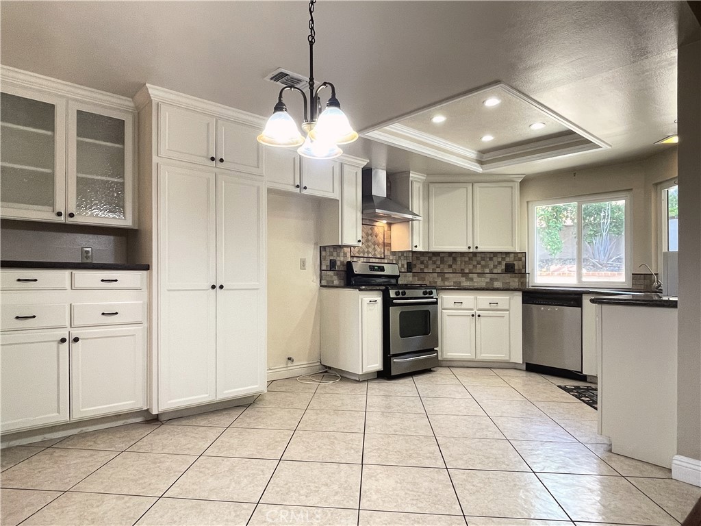 20665 Fuero Drive Walnut, CA 91789 - Photo 13 of 47 a kitchen with granite countertop a stove a sink and a refrigerator