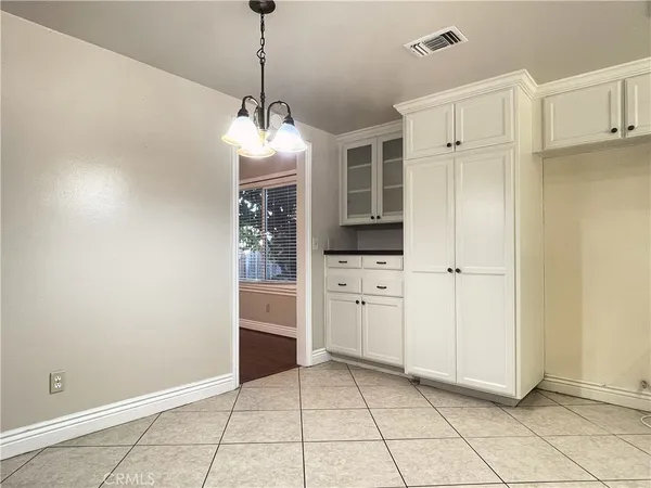 a view of a storage & utility room with cabinets
