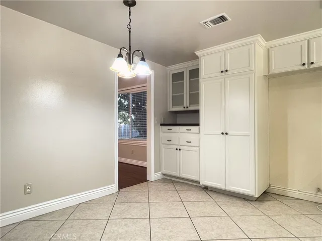 a view of a storage & utility room with cabinets