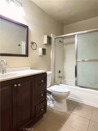 a bathroom with a double vanity sink mirror and toilet