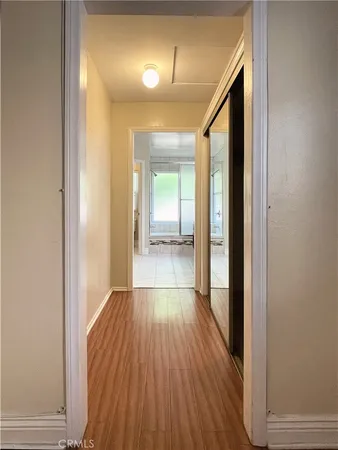 a view of a hallway with wooden floor
