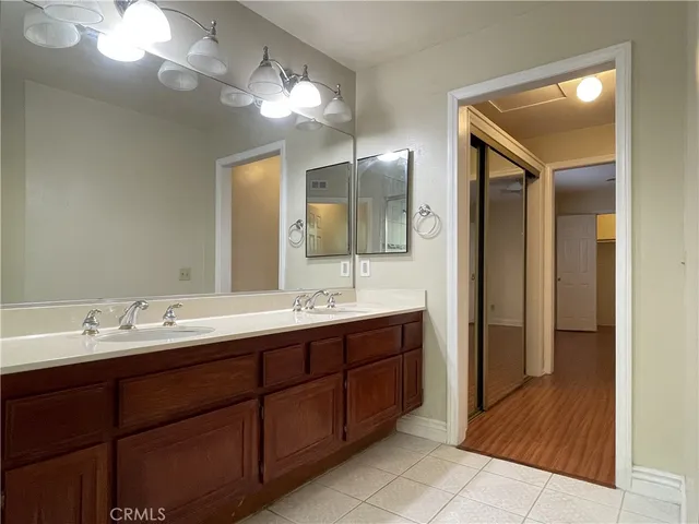 a bathroom with a double vanity sink and a mirror