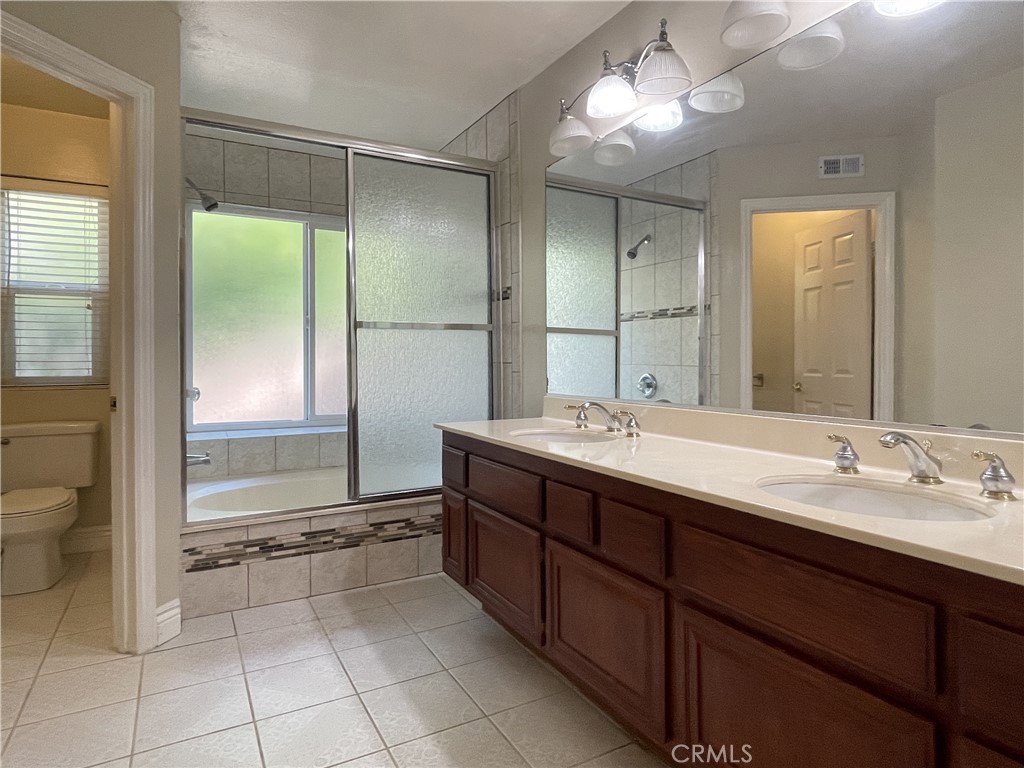 20665 Fuero Drive Walnut, CA 91789 - Photo 31 of 47 a spacious bathroom with a double vanity sink and a mirror