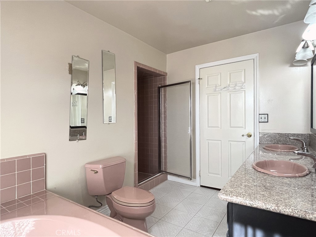 20665 Fuero Drive Walnut, CA 91789 - Photo 41 of 47 a bathroom with a granite countertop sink a toilet a mirror and shower