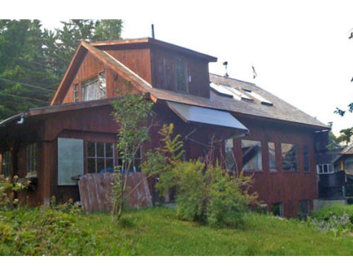 653 Bear Swamp Road Ashfield, MA 01330 - Photo 1 of 1 a view of a house with brick walls and a yard with plants