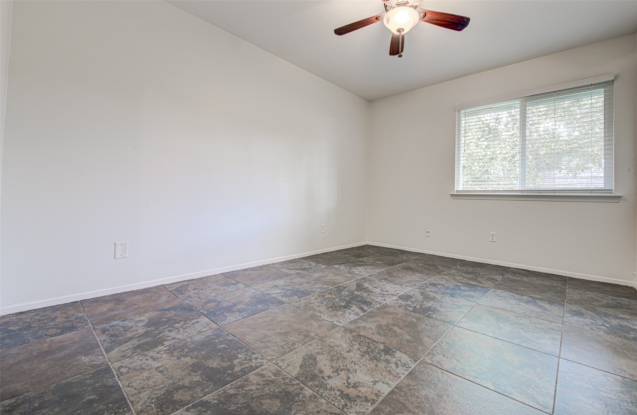 1403 Click Cove, Unit A Austin, TX 78758 - Photo 11 of 16 Bedroom 2 with tile flooring and ceiling fan. No carpet