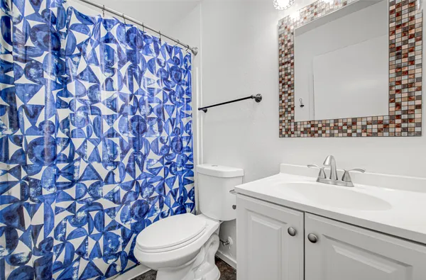 a bathroom with a sink toilet and mirror