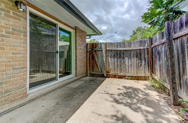 a backyard of a house with table and chairs