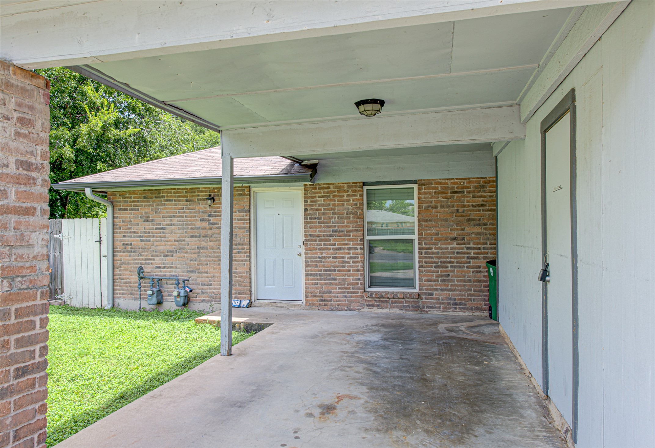 1403 Click Cove, Unit A Austin, TX 78758 - Photo 2 of 16 Carport with storage area