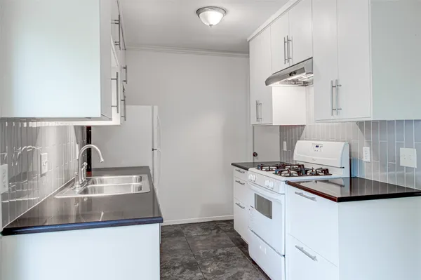 a kitchen that has a sink and a stove