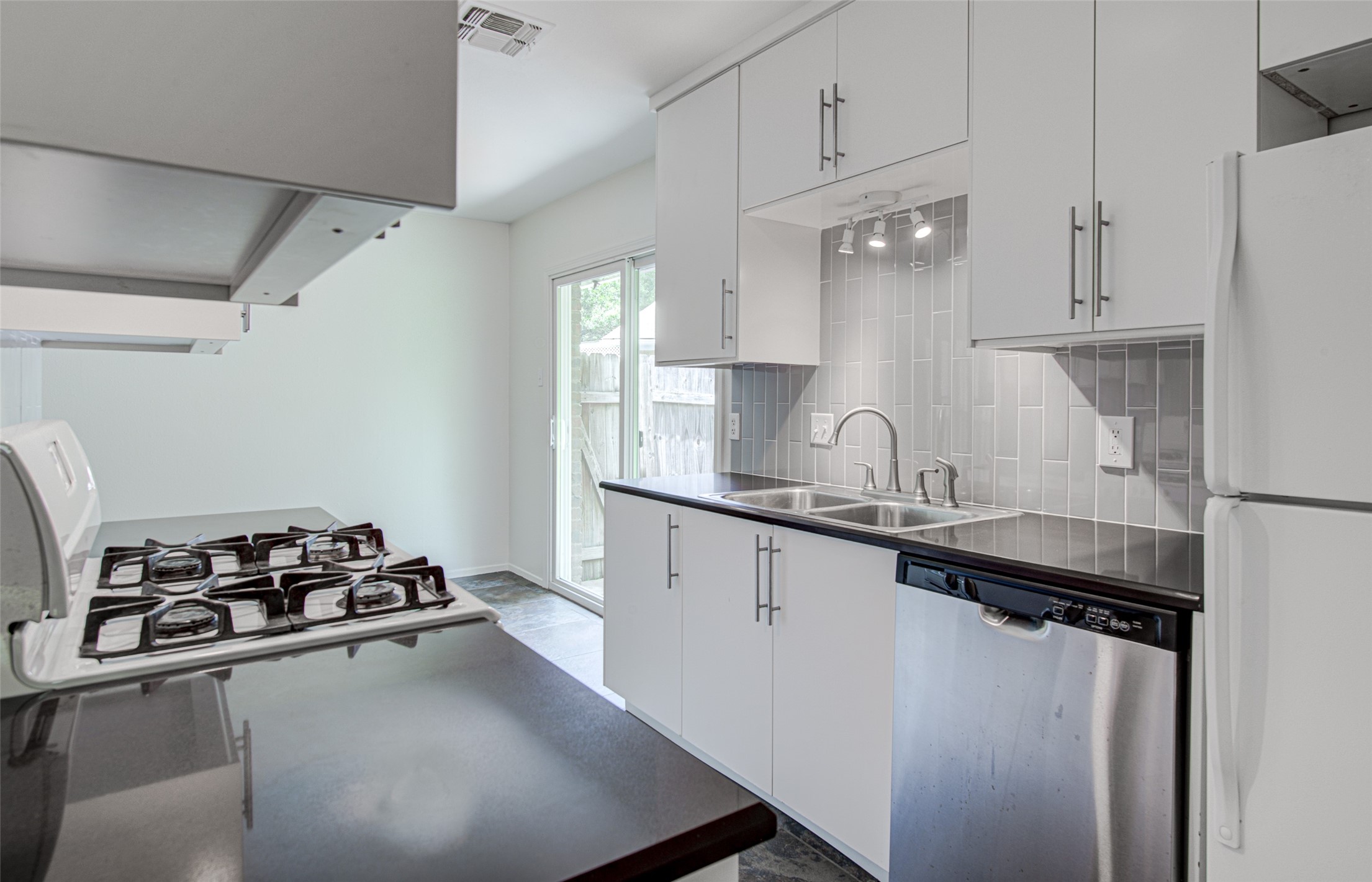 1403 Click Cove, Unit A Austin, TX 78758 - Photo 9 of 16 Dishwasher and refrigerator