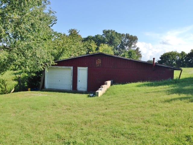 3545 3 Island Road Walling, TN 38587 - Photo 8 of 26 46x40 storage building with roll-up door and walk through door.