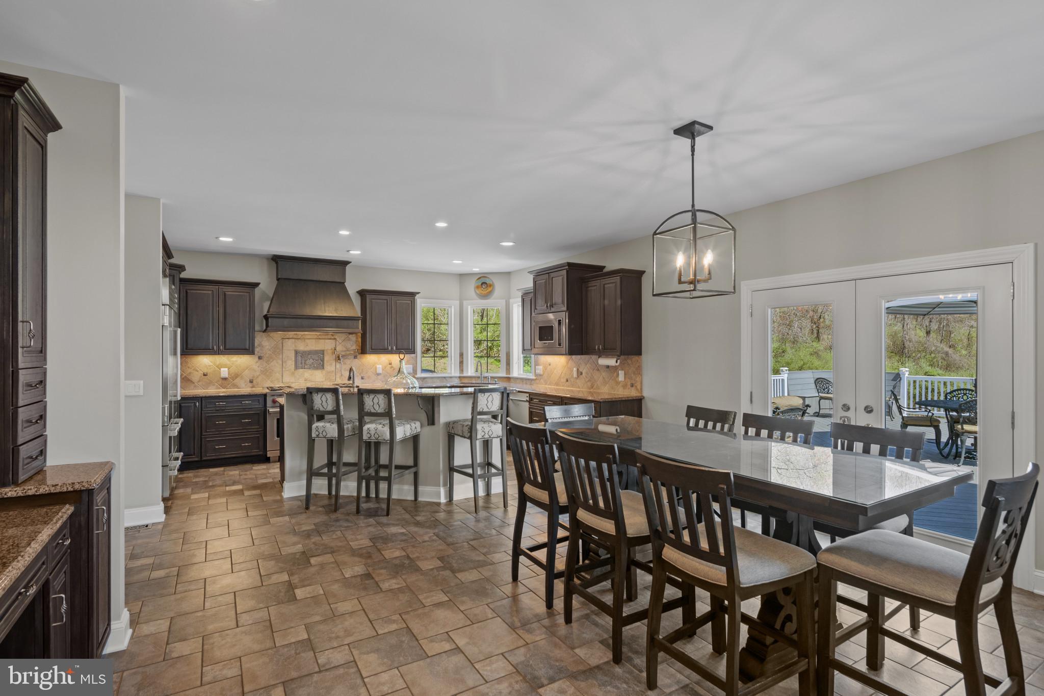 1140 Bernoudy Road White Hall, MD 21161 - Photo 22 of 81 a dining area with a table chairs and a kitchen view