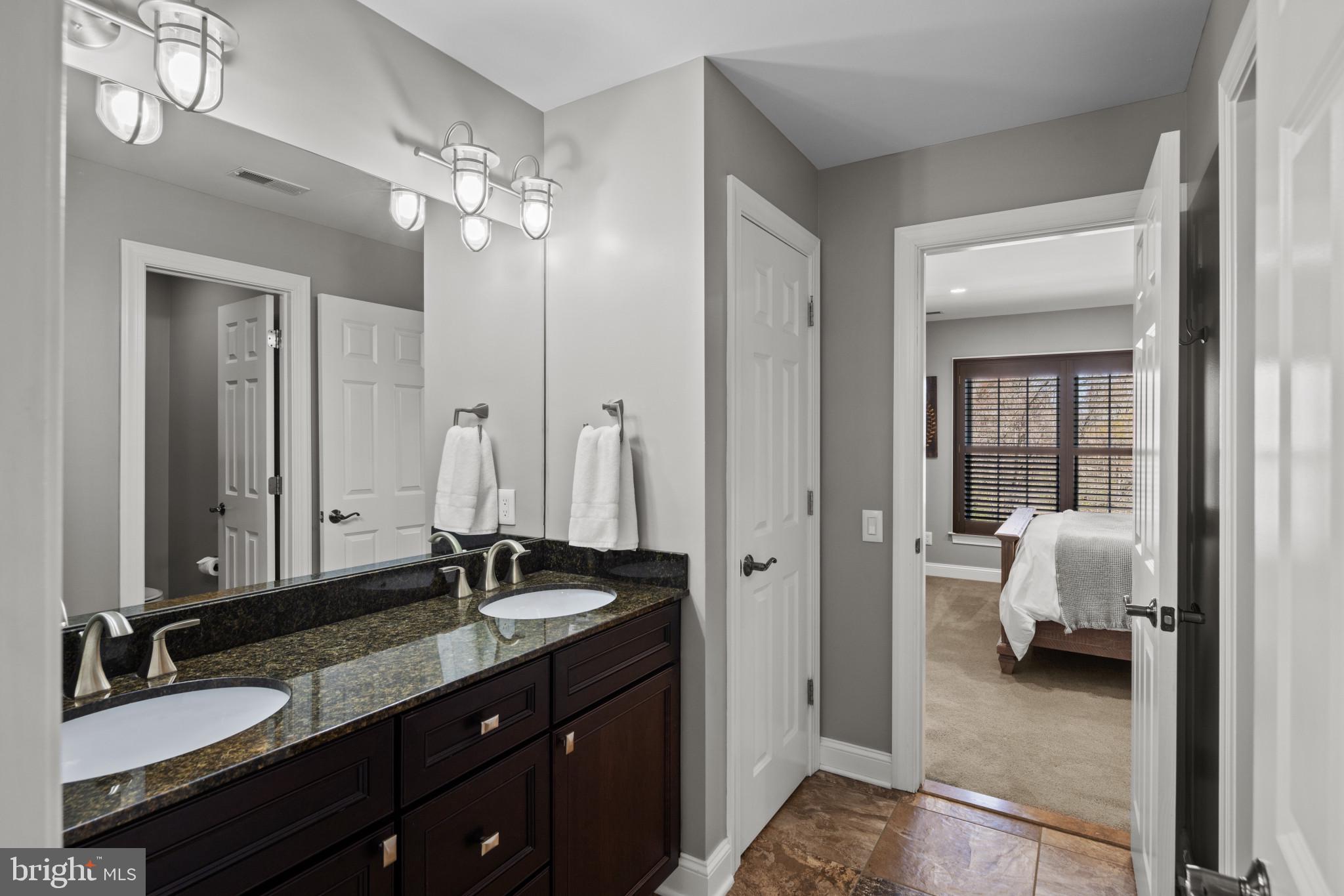 1140 Bernoudy Road White Hall, MD 21161 - Photo 42 of 81 a en suite bathroom with a granite countertop sink and a mirror