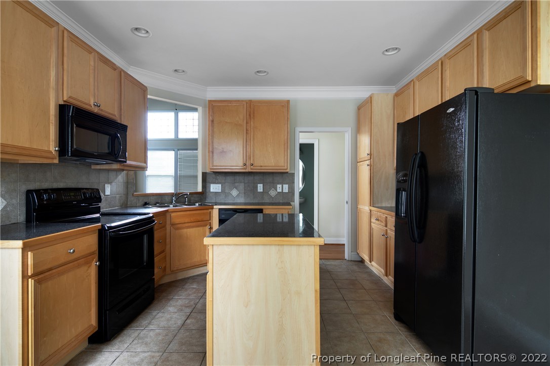 187 Lamplighter Way Spring Lake, NC 28390 - Photo 14 of 48 a kitchen with stainless steel appliances granite countertop a refrigerator a stove top oven a sink and dishwasher