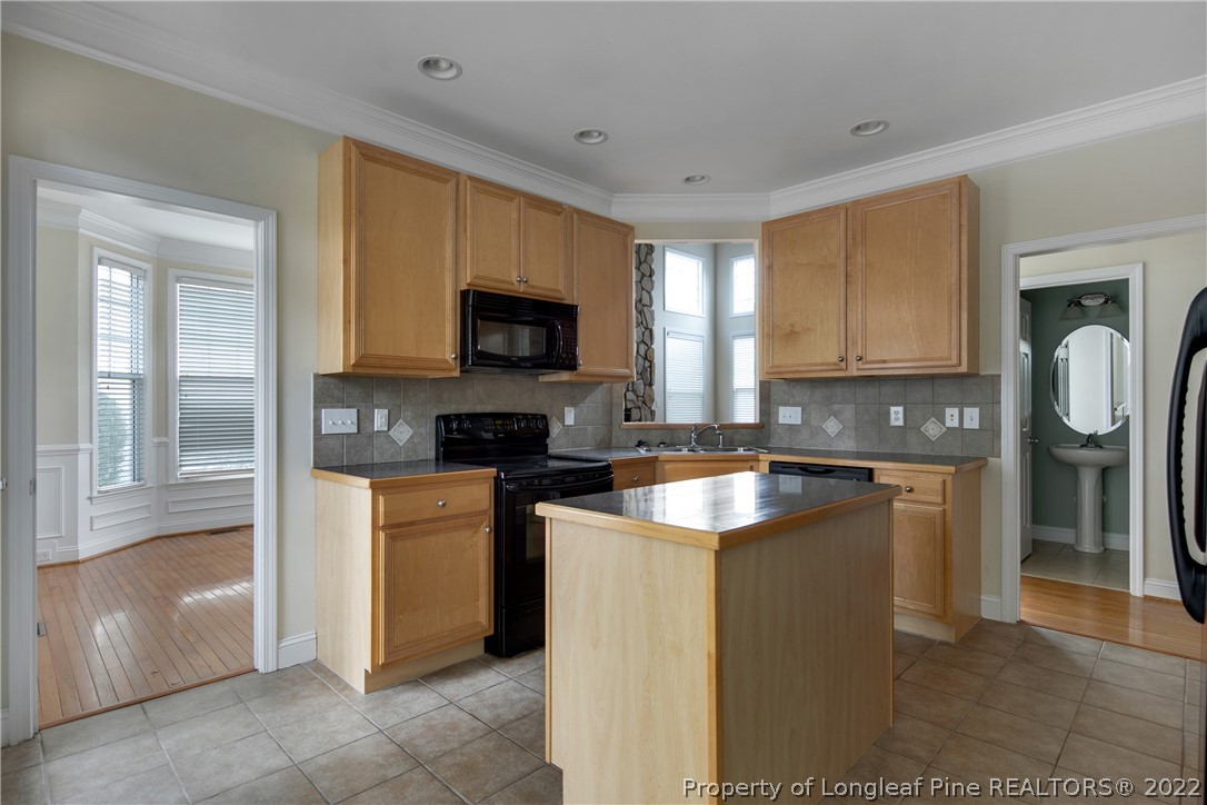 187 Lamplighter Way Spring Lake, NC 28390 - Photo 15 of 48 a kitchen with stainless steel appliances granite countertop a stove a sink and a microwave