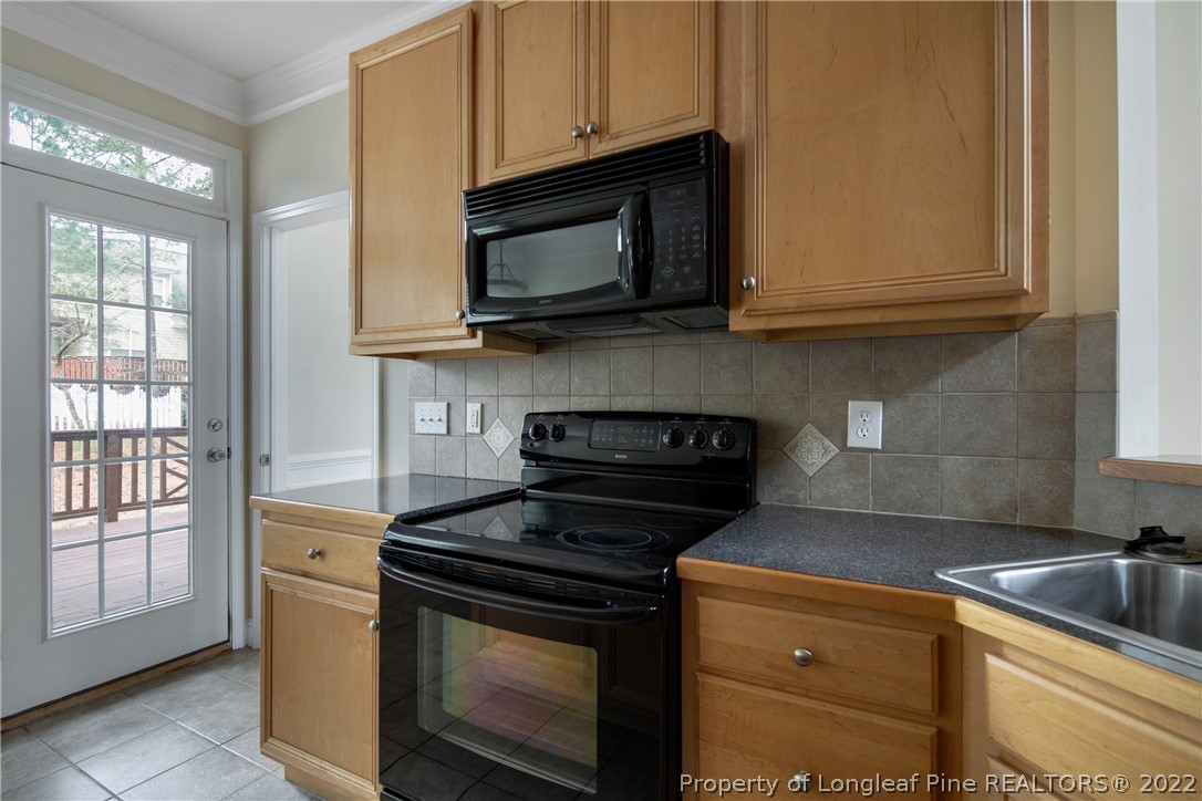 187 Lamplighter Way Spring Lake, NC 28390 - Photo 17 of 48 a kitchen with stainless steel appliances granite countertop white cabinets a stove a sink and dishwasher