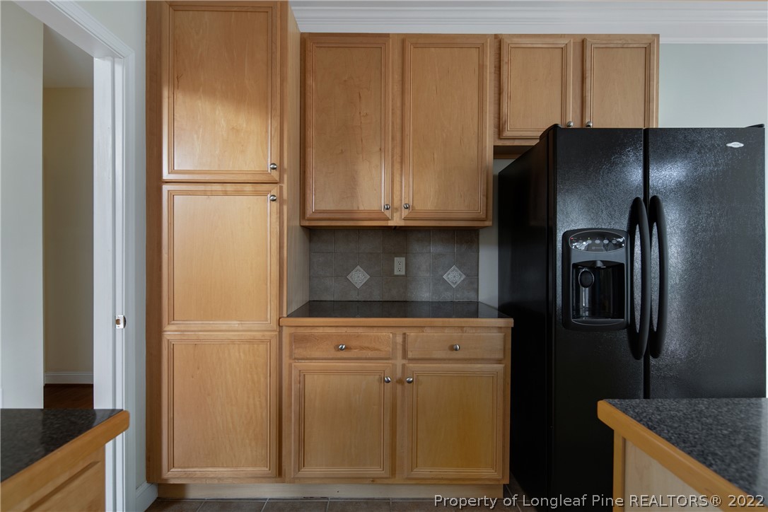 187 Lamplighter Way Spring Lake, NC 28390 - Photo 18 of 48 a kitchen with metallic refrigerator freezer and a granite counter tops