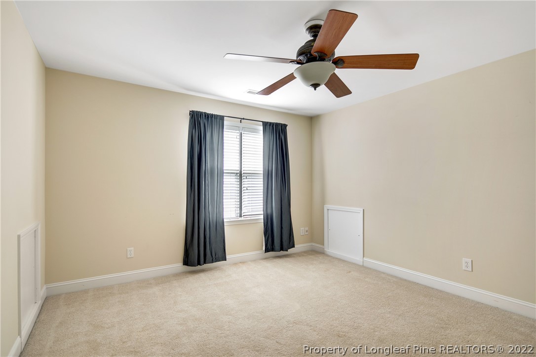 187 Lamplighter Way Spring Lake, NC 28390 - Photo 41 of 48 an empty room with ceiling fan and window