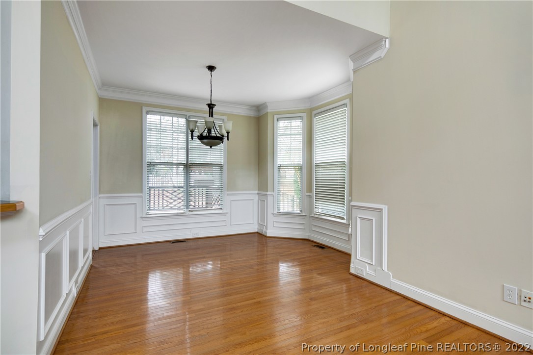 187 Lamplighter Way Spring Lake, NC 28390 - Photo 10 of 48 a view of an empty room with wooden floor and a window