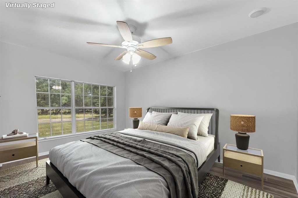 7 Market Loop Morgan's Point Resort, TX 76513 - Photo 23 of 31 Bright room featuring a window, wood-finish flooring, a ceiling fan with light fixture. Virtually staged