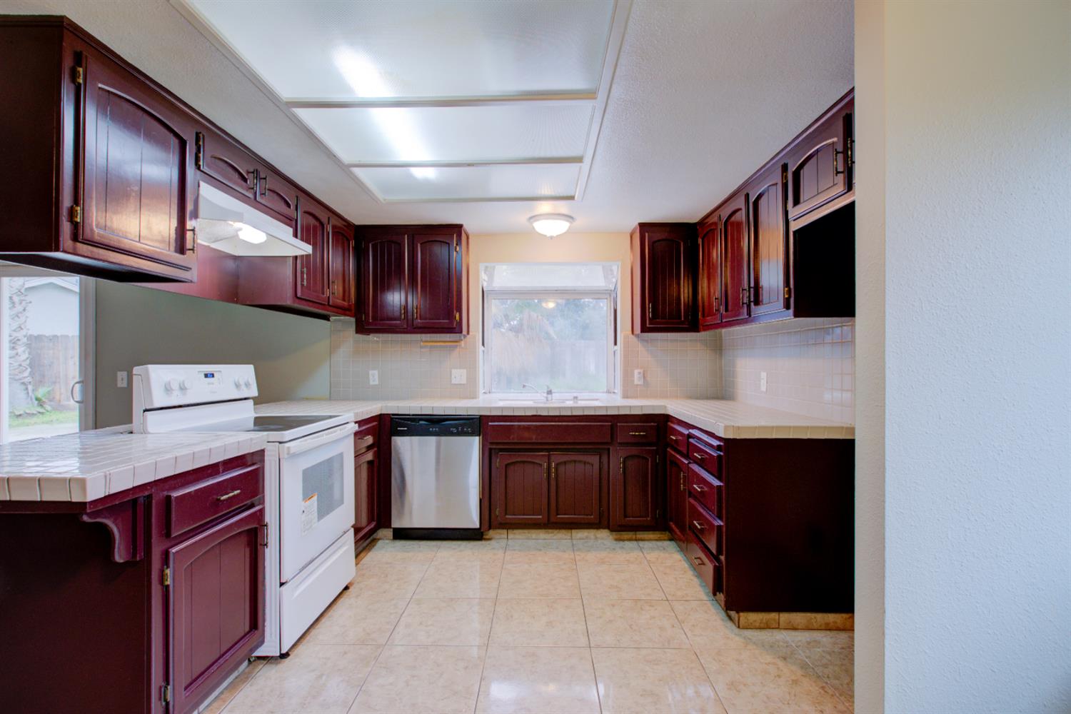 3772 Duke Court Merced, CA 95348 - Photo 13 of 40 a large kitchen with stainless steel appliances granite countertop a stove sink and cabinets