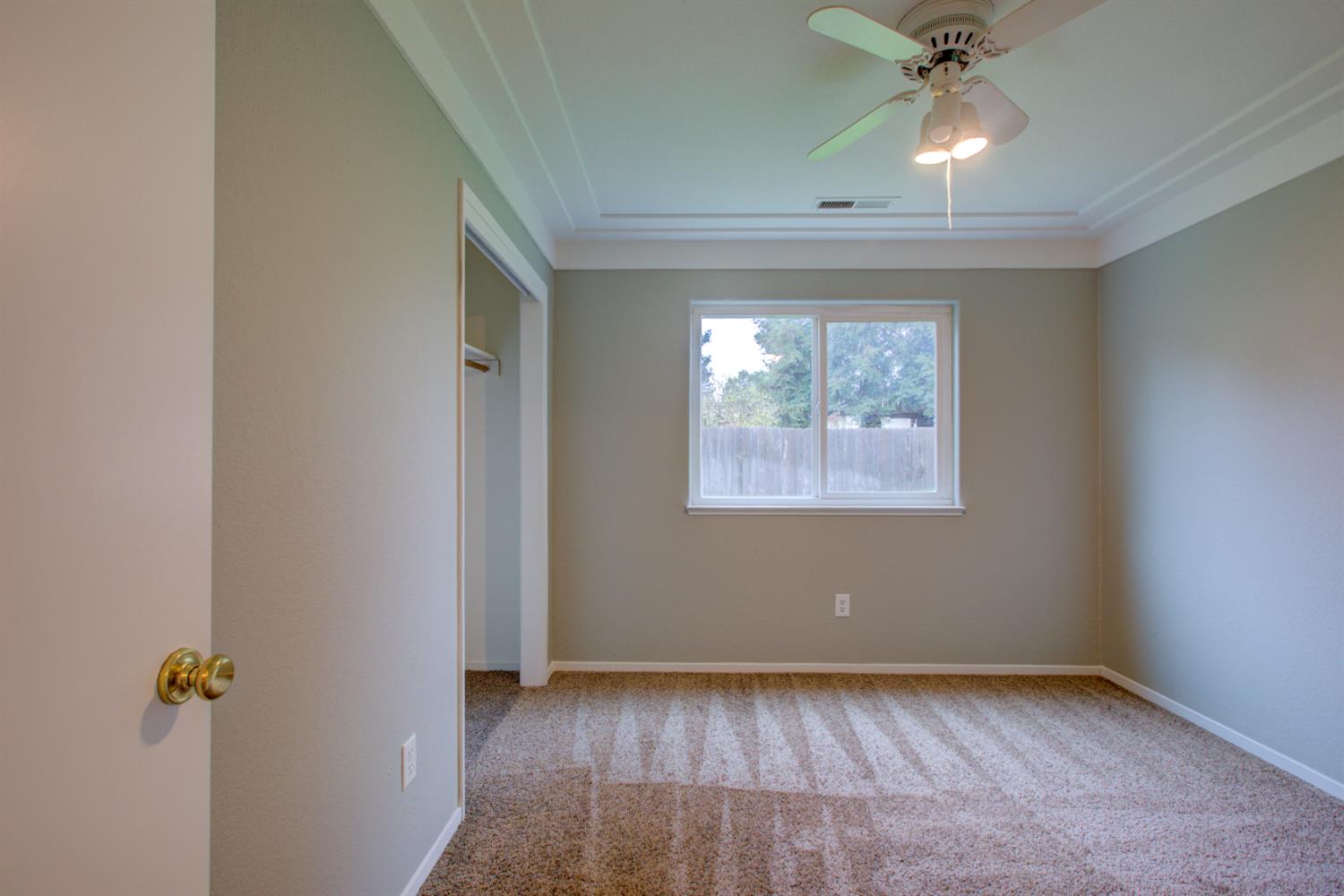 3772 Duke Court Merced, CA 95348 - Photo 21 of 40 an empty room with windows and fan