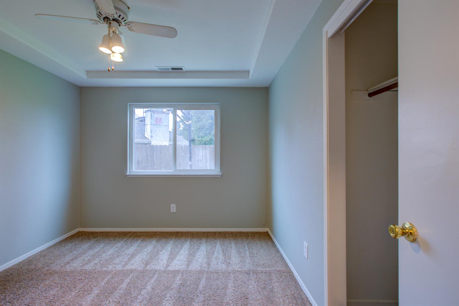 3772 Duke Court Merced, CA 95348 - Photo 23 of 40 a view of empty room with wooden floor and fan