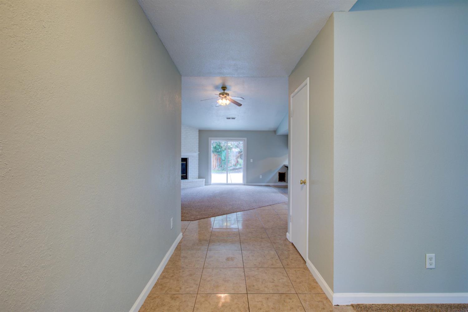 3772 Duke Court Merced, CA 95348 - Photo 3 of 40 a view of a hallway with a chandelier and a rug