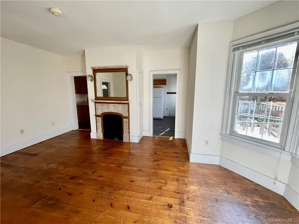 a view of empty room with window and fireplace