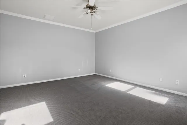 an empty room with a chandelier fan