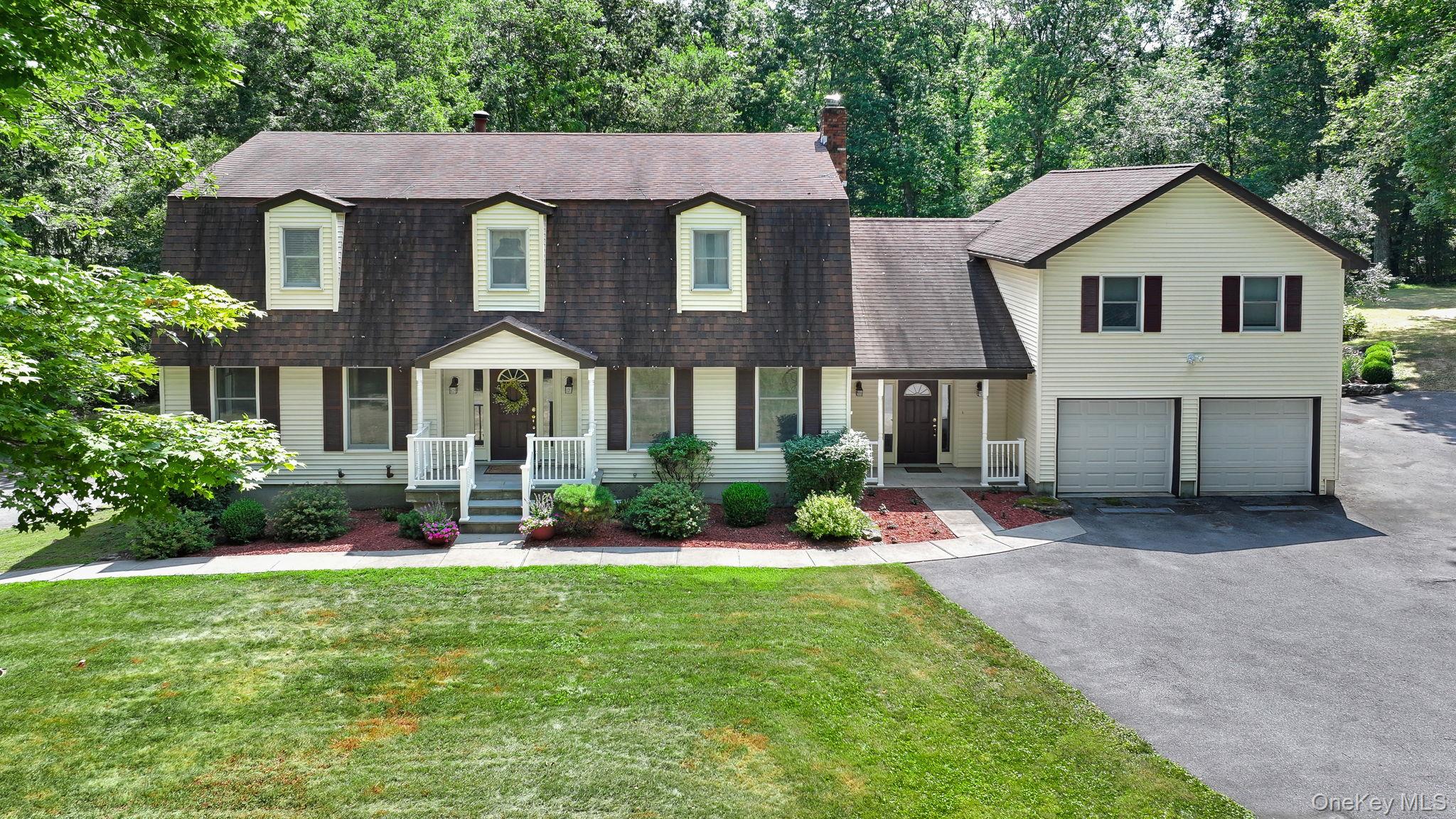 a front view of a house with a yard and porch