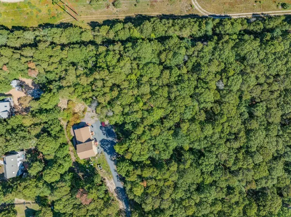 a aerial view of a house with a yard and outdoor seating