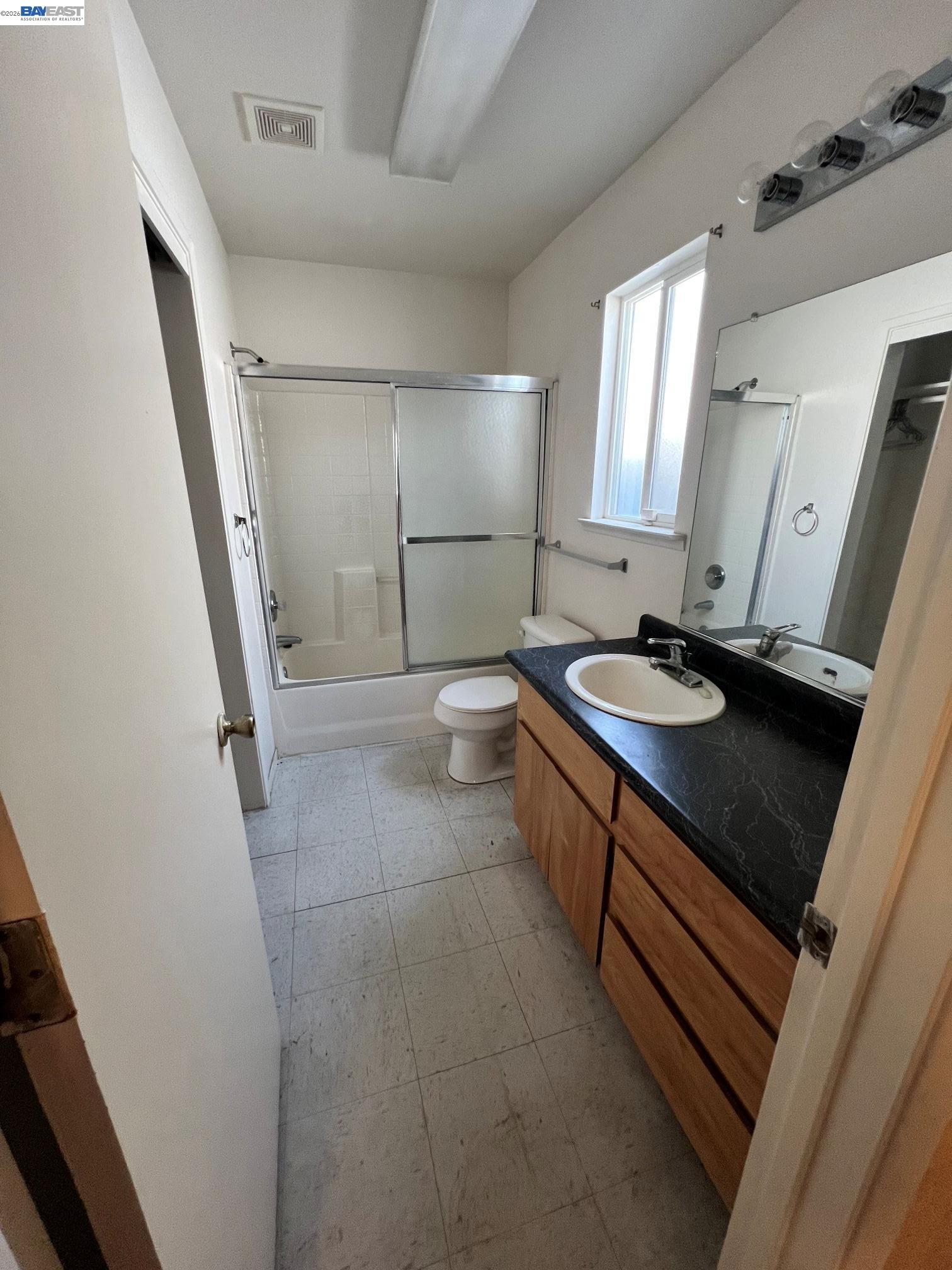192 Torvend Way Patterson, CA 95363 - Photo 20 of 29 a bathroom with a sink a toilet a mirror and shower