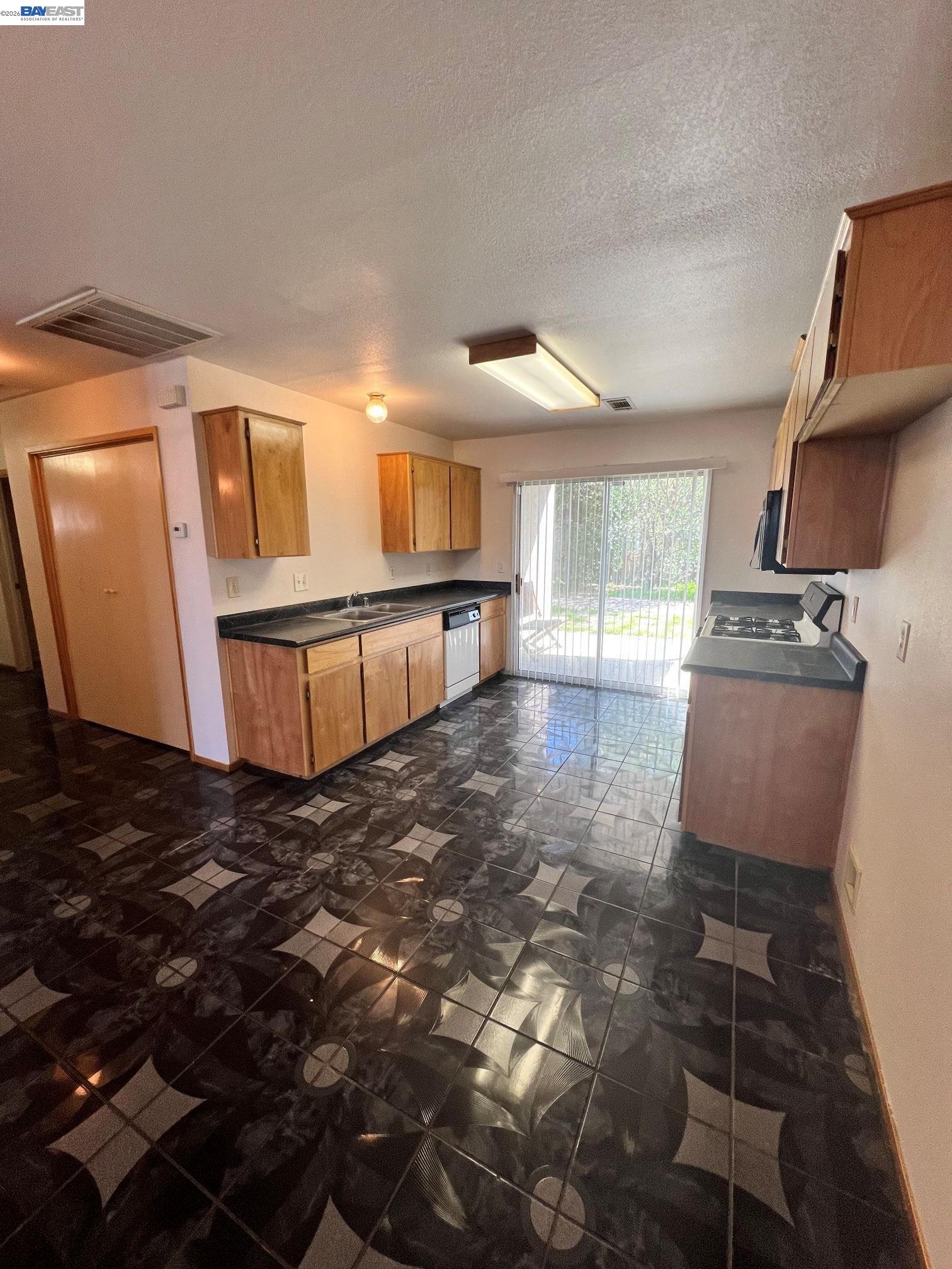 192 Torvend Way Patterson, CA 95363 - Photo 8 of 29 a view of a kitchen with wooden floor and a sink
