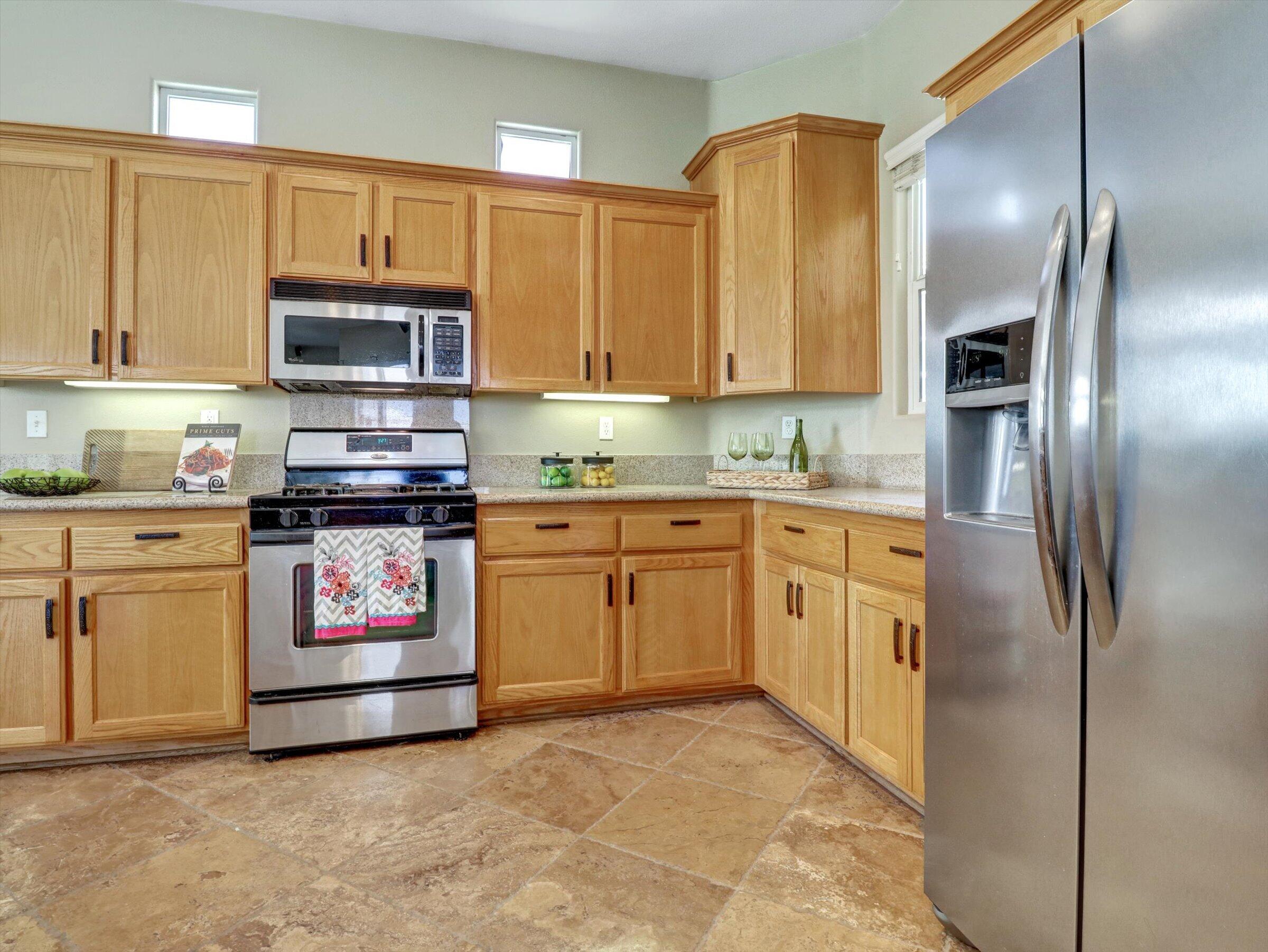 82809 Odlum Drive Indio, CA 92201 - Photo 20 of 57 a kitchen with stainless steel appliances granite countertop a stove a sink and a refrigerator