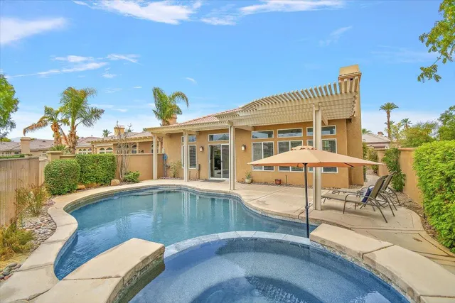swimming pool view with a seating space