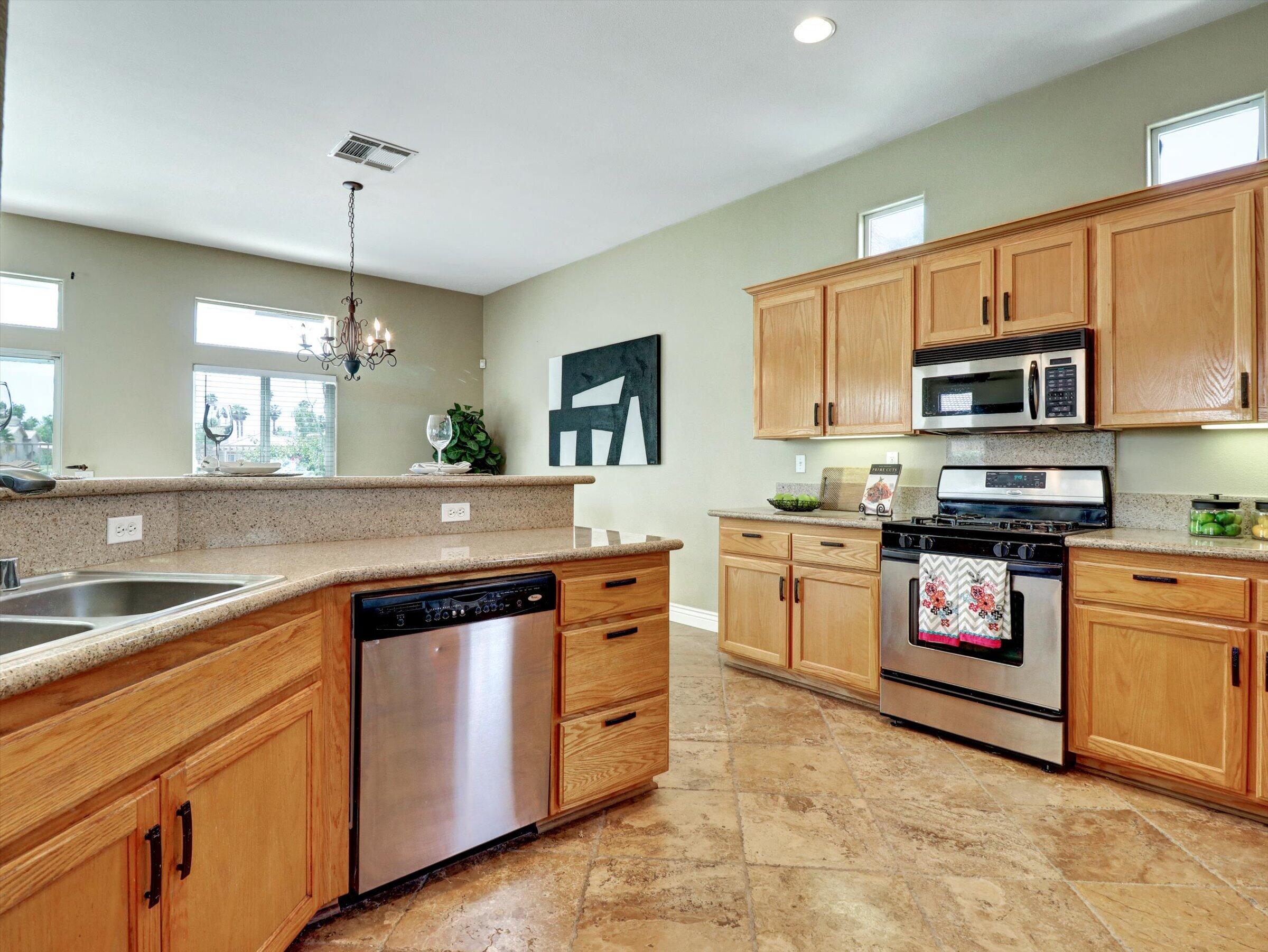 82809 Odlum Drive Indio, CA 92201 - Photo 21 of 57 a kitchen with a sink stove and microwave