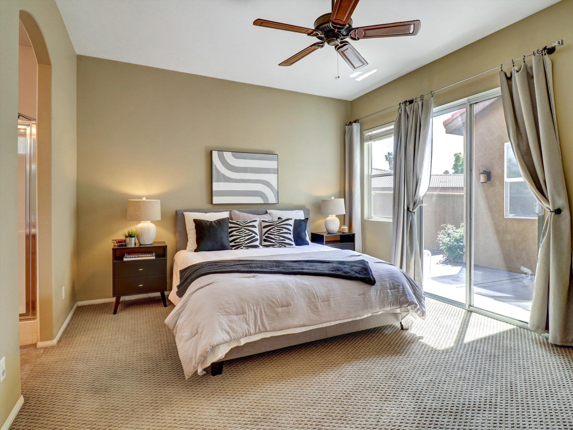 82809 Odlum Drive Indio, CA 92201 - Photo 22 of 57 a bedroom with a bed and a chandelier