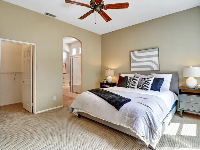 a bedroom with a bed and a lamp