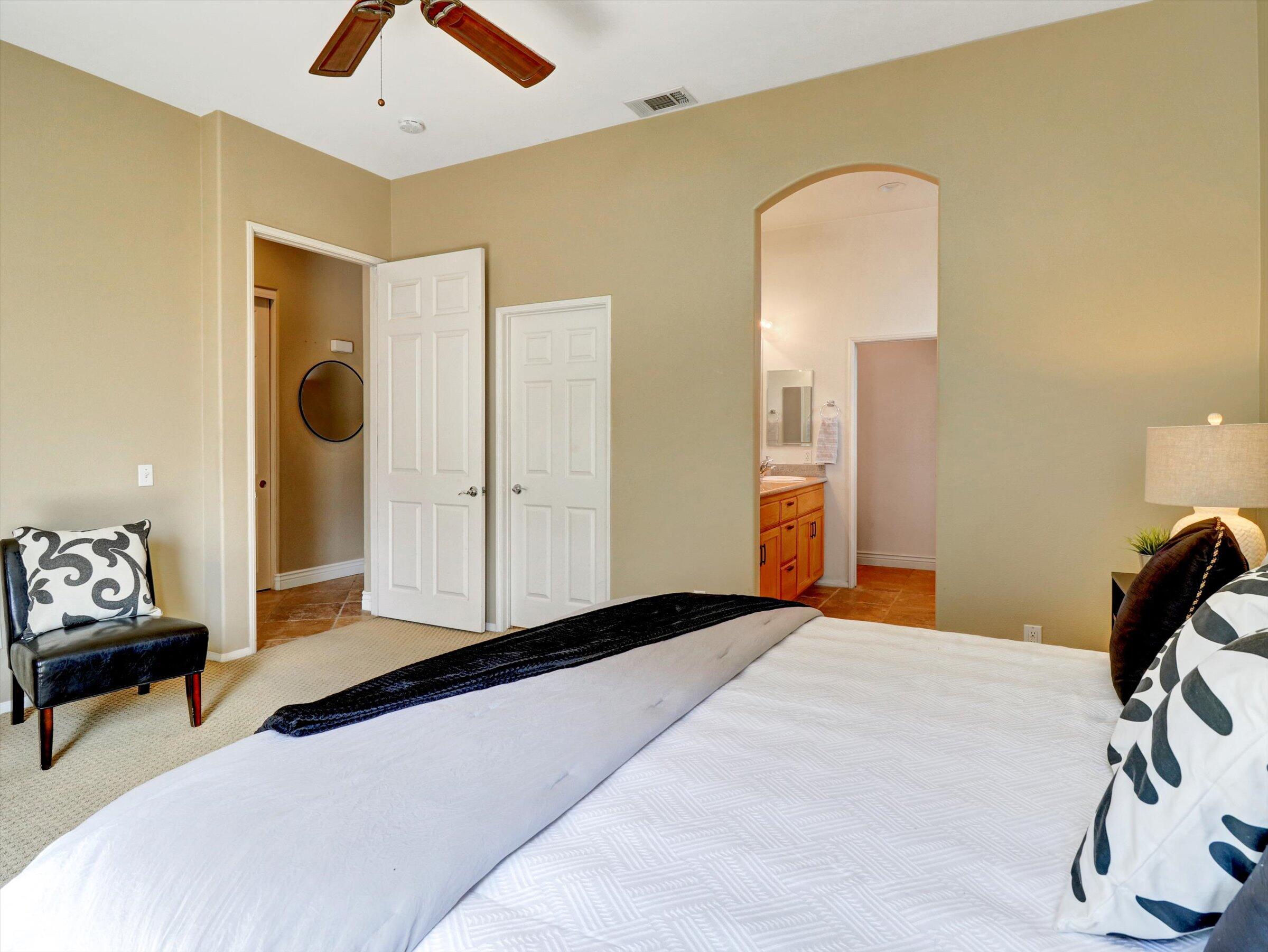 82809 Odlum Drive Indio, CA 92201 - Photo 24 of 57 a bedroom with a bed and a chandelier