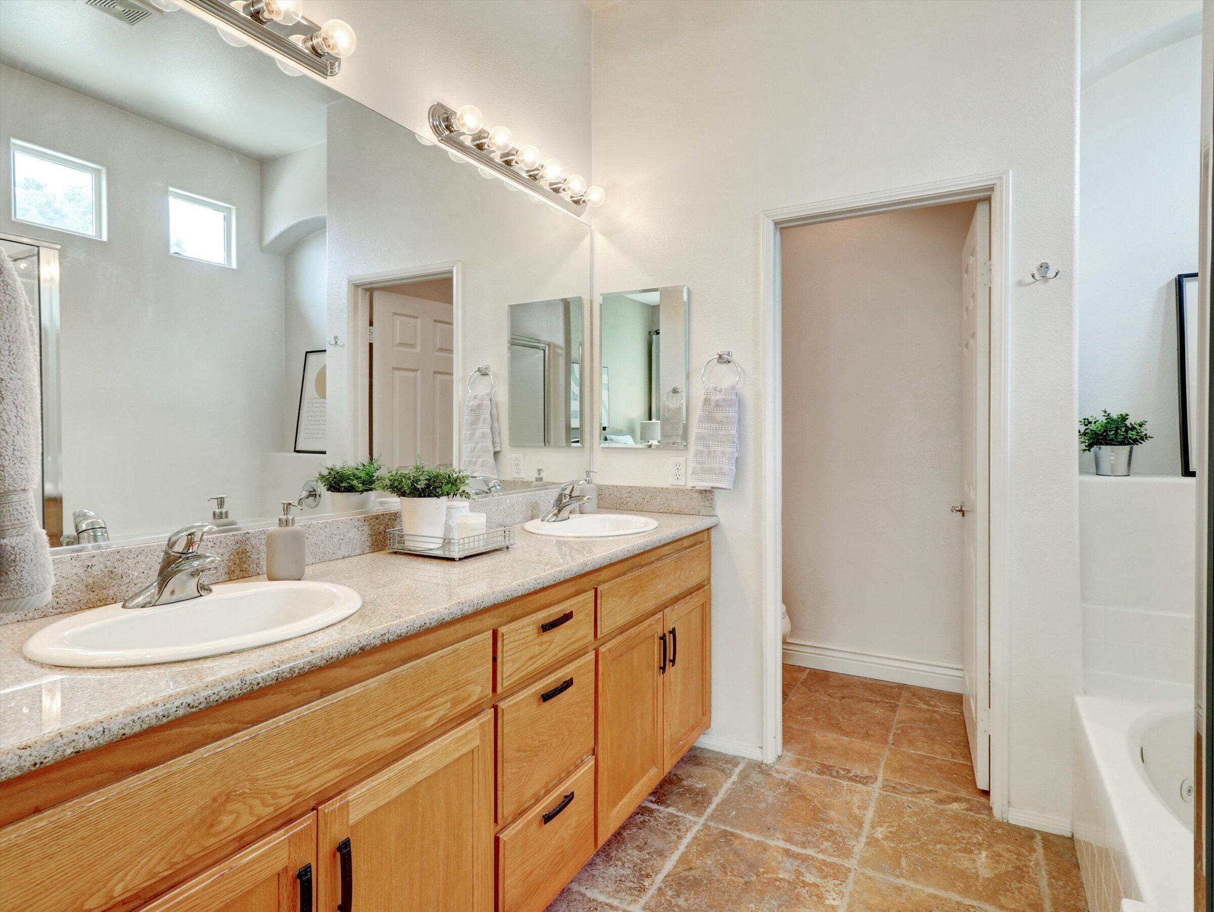 82809 Odlum Drive Indio, CA 92201 - Photo 25 of 57 a spacious bathroom with a double vanity sink a mirror and a shower