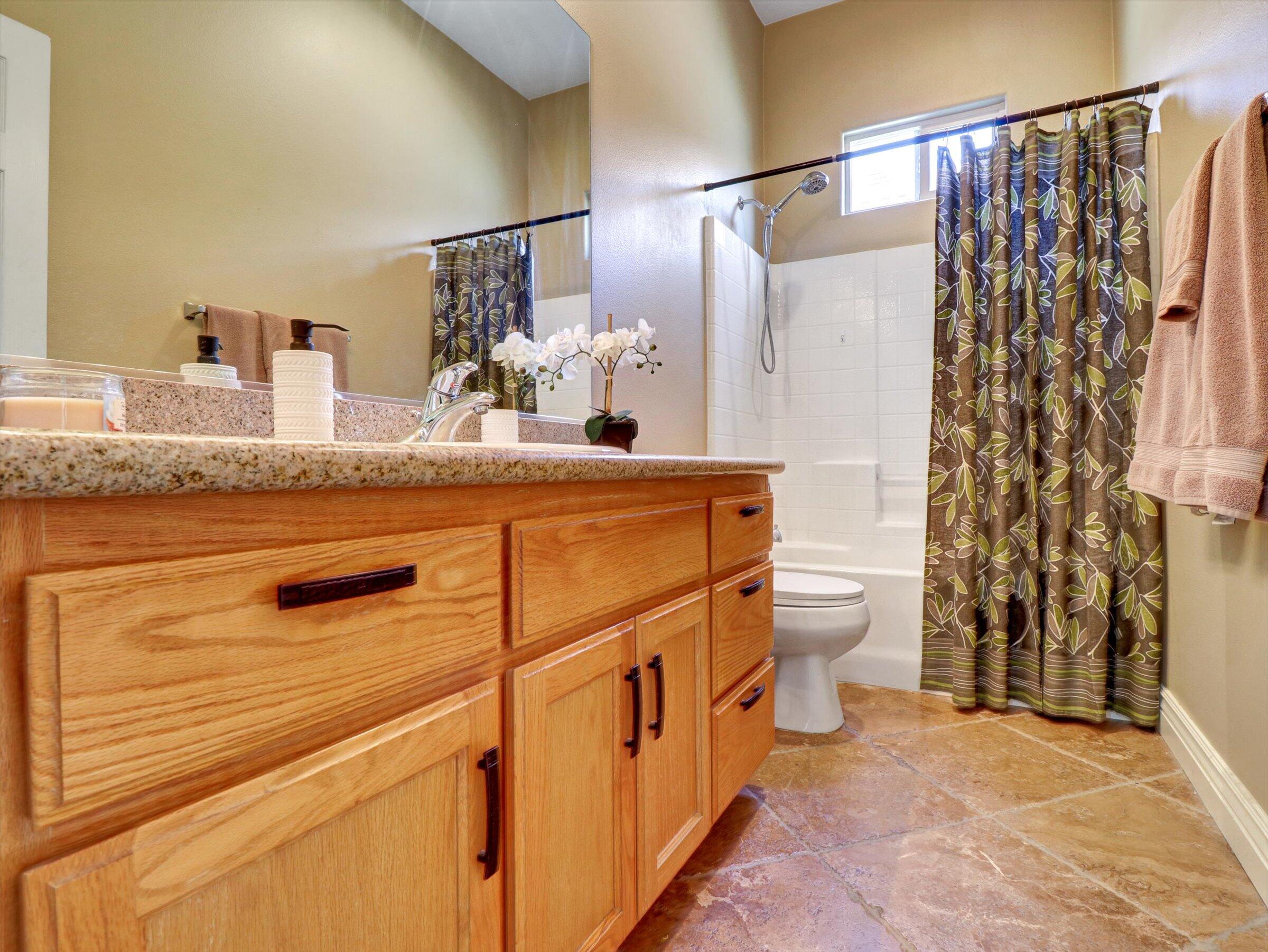 82809 Odlum Drive Indio, CA 92201 - Photo 31 of 57 a bathroom with a granite countertop sink and a mirror