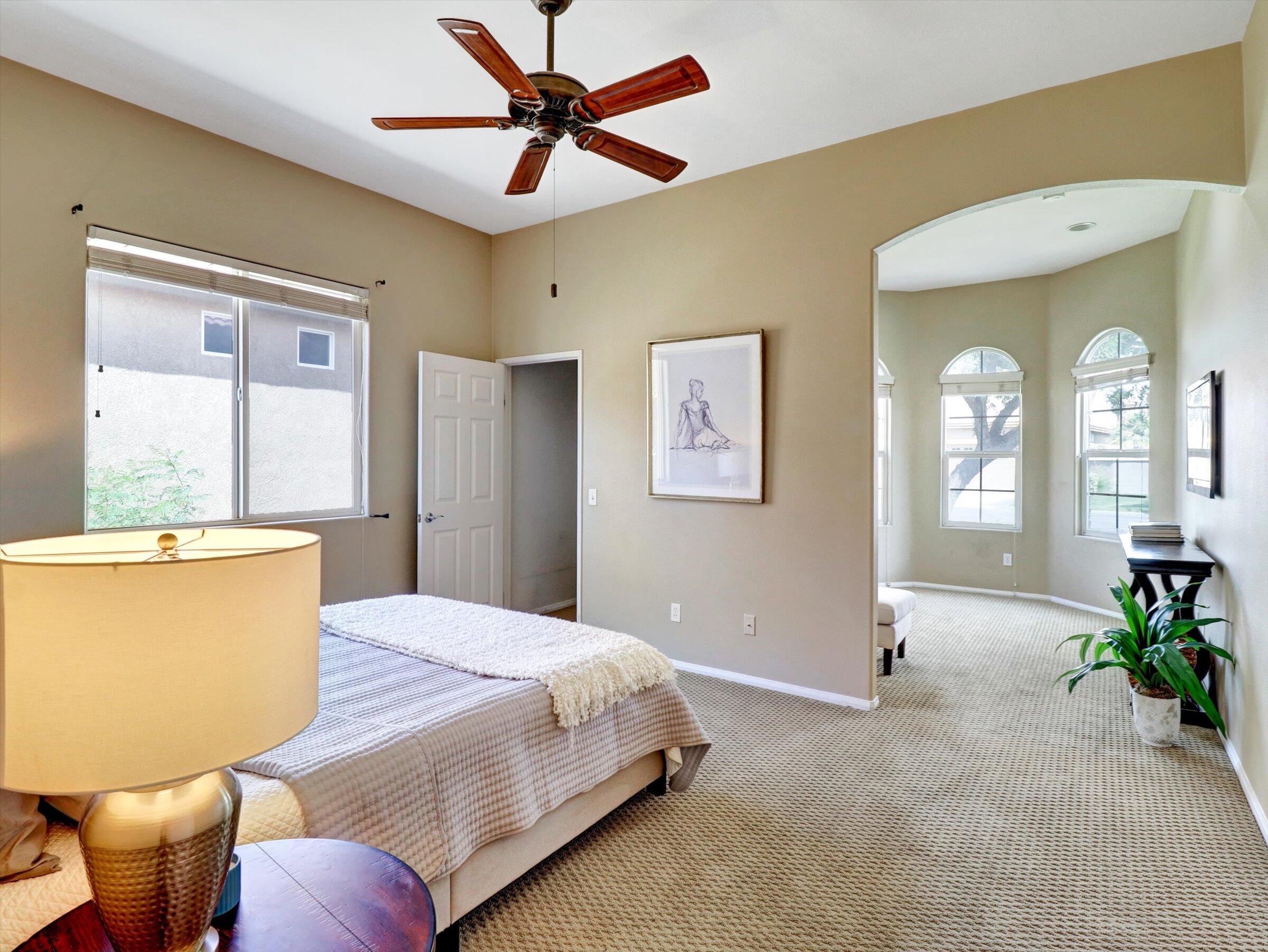 82809 Odlum Drive Indio, CA 92201 - Photo 32 of 57 a bedroom with a large bed chandelier and a window