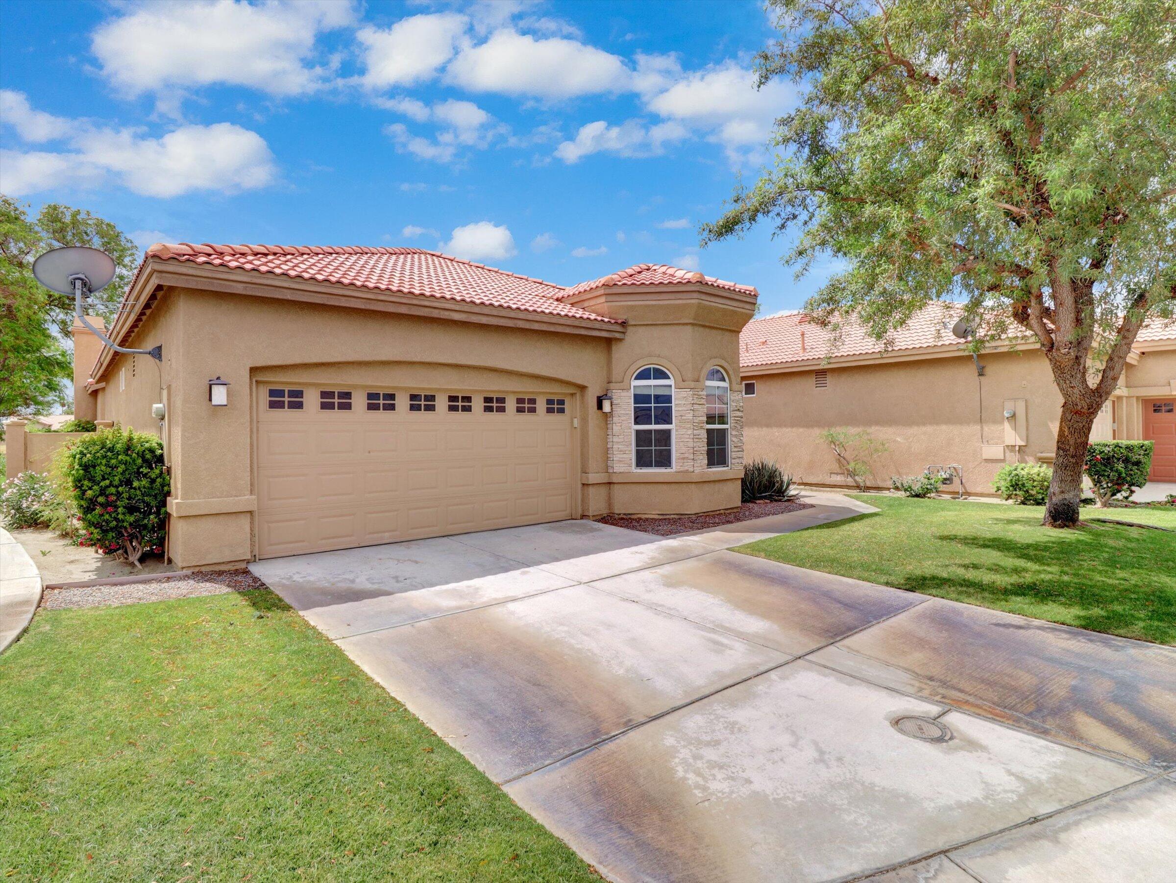82809 Odlum Drive Indio, CA 92201 - Photo 54 of 57 a front view of a house with a yard and garage